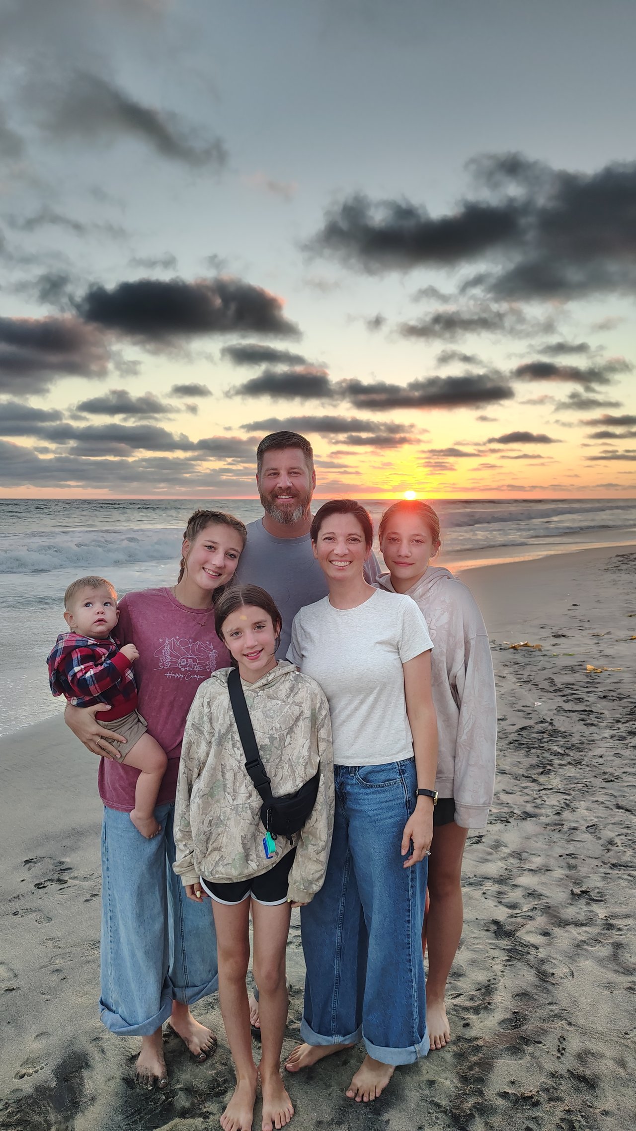The Miller family on the beach at sunset: Jared, Amber, Kiah, Zoe, Phoebe, and Derek.